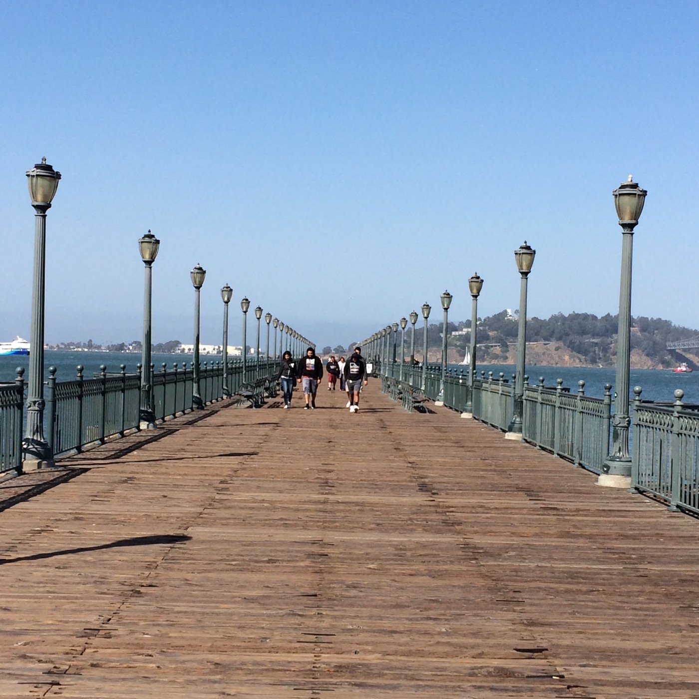 A long waterfront pier lined with lamps