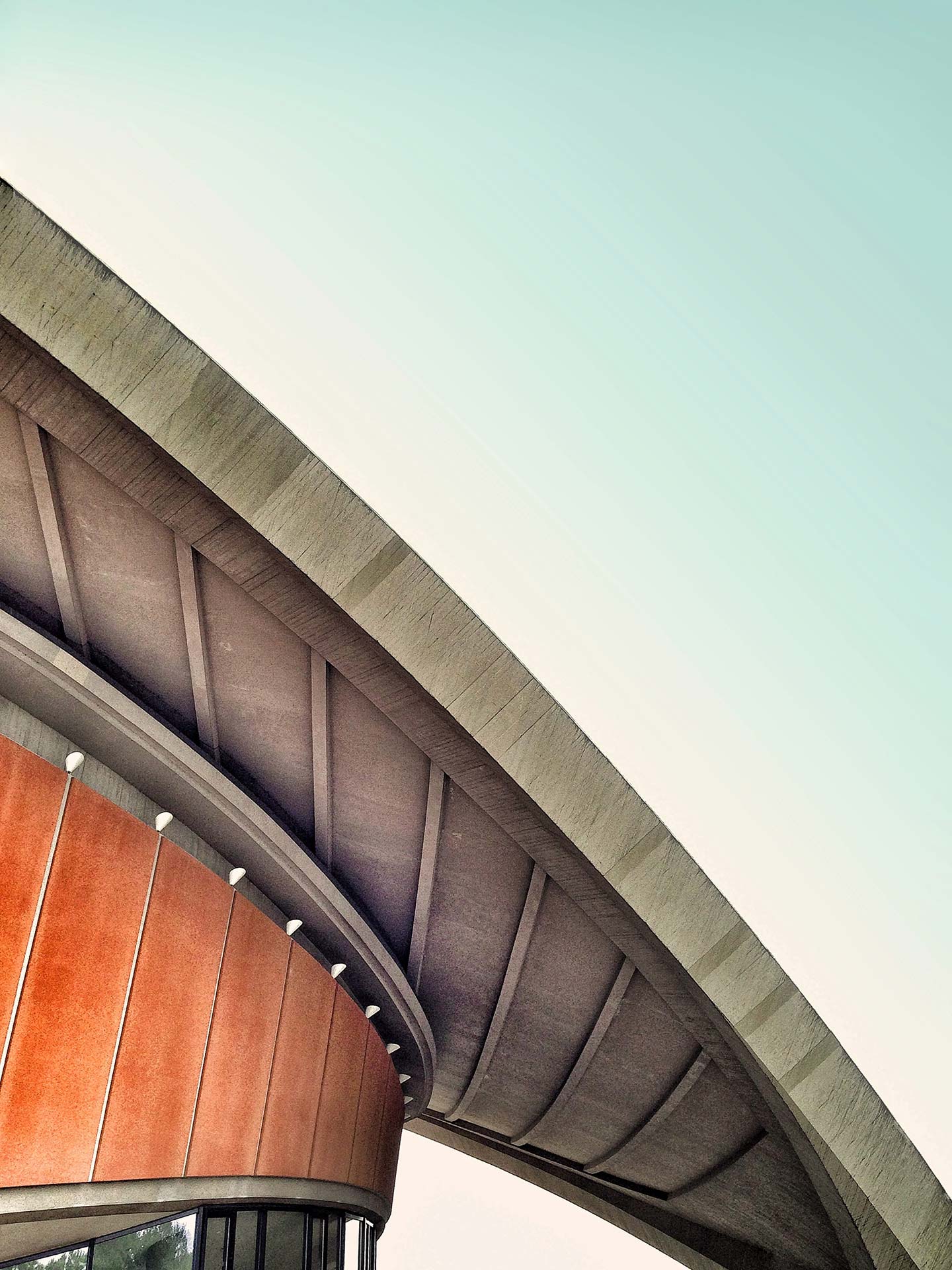 Modern architectural curves beneath a blue sky